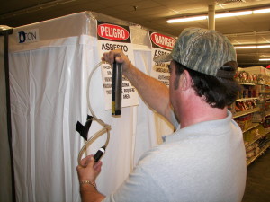 Robert Kinsely testing air calibration for asbestos detection and removal